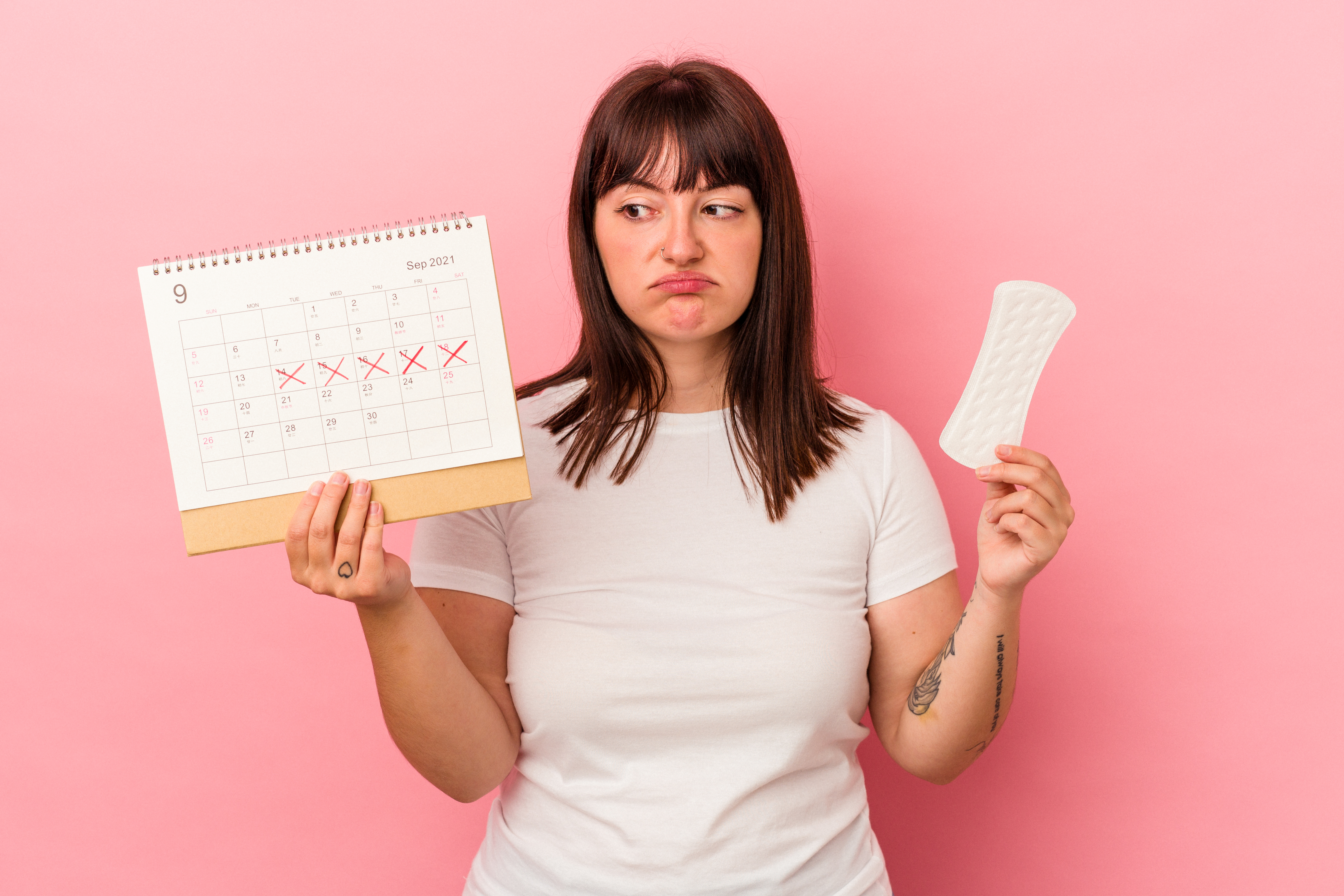 Woman holding a calendar and a pad